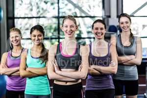 Smiling women posing together with arms crossed