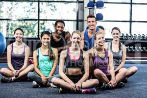 Smiling fitness class posing together