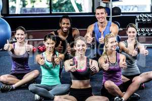 Smiling fitness class posing together