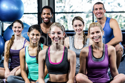 Smiling fitness class posing together Smiling fitness class posing together