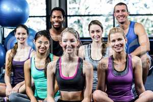 Smiling fitness class posing together