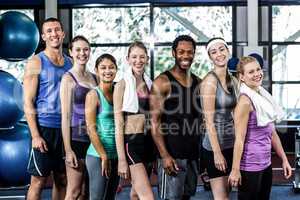 Smiling fitness class posing together