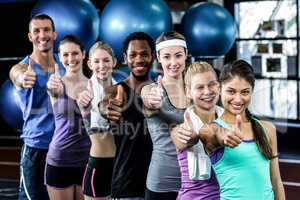 Smiling fitness class posing together