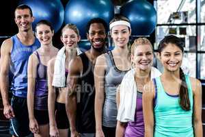 Smiling fitness class posing together
