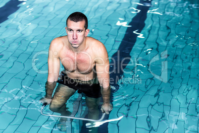 Fit man cycling in the pool