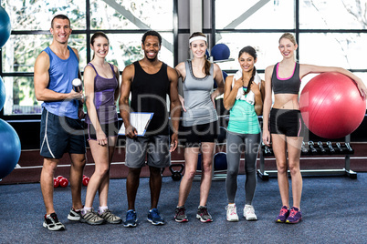 Smiling fitness class posing together