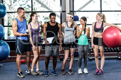 Smiling fitness class posing together