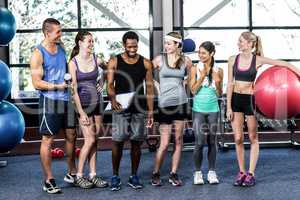 Smiling fitness class posing together