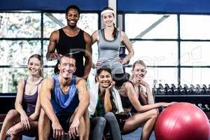 Smiling fitness class posing together