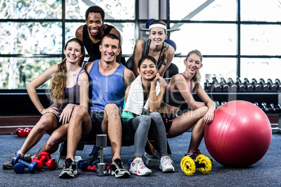 Smiling fitness class posing together