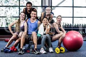 Smiling fitness class posing together