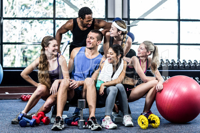 Smiling fitness class posing together