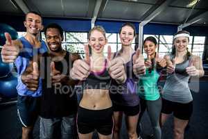 Smiling fitness class posing together