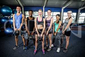 Class and instructor exercising with kettlebells