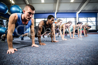 Fit people working out in fitness class