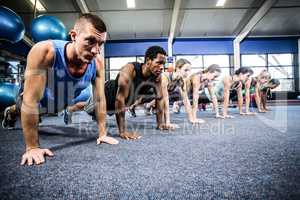 Fit people working out in fitness class