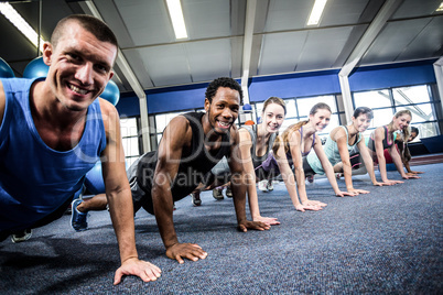 Fit people working out in fitness class