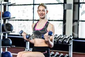 Fit woman exercising with dumbbells