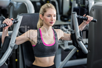 Fit woman using exercise machine