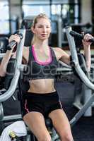 Fit woman using exercise machine