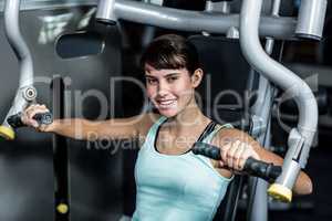 Fit woman using exercise machine