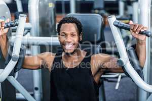 Smiling man using exercise machine