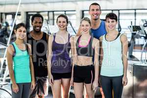 Smiling fitness class posing together