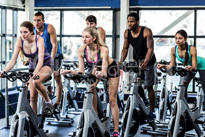 Fit people working out at spinning class