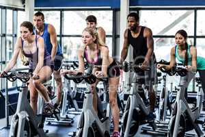 Fit people working out at spinning class