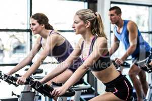 Fit people working out at spinning class