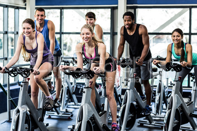 Fit people working out at spinning class