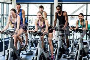 Fit people working out at spinning class