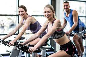 Fit people working out at spinning class