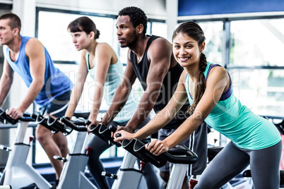 Fit people working out at spinning class