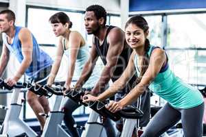 Fit people working out at spinning class