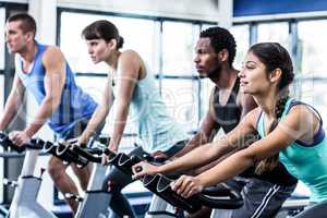 Fit people working out at spinning class