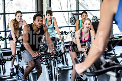 Fit people working out at spinning class