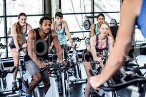 Fit people working out at spinning class