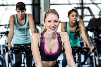 Fit woman working out at spinning class