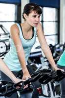 Fit woman working out at spinning class