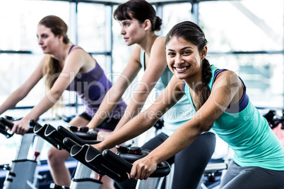 Fit woman working out at spinning class