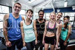 Smiling fitness class posing together