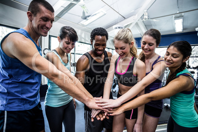 Fit people putting their hands together