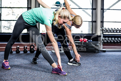 Fit women stretching in the gym