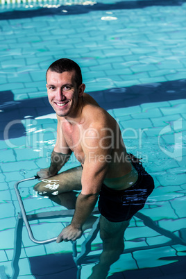 Fit man cycling in the pool