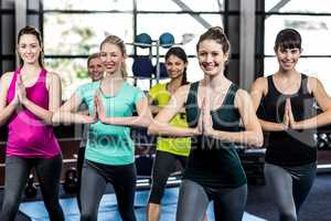 Fitness class doing yoga exercises