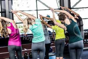 Fitness class doing yoga exercises