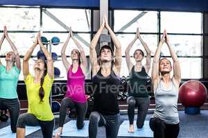 Fitness class doing yoga exercises