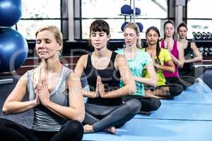 Fitness class doing yoga exercises