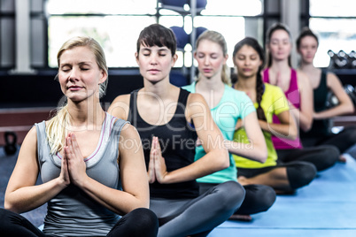 Fitness class doing yoga exercises Fitness class doing yoga exercises
